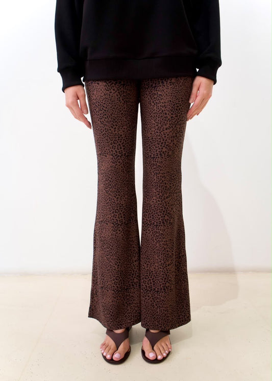 Front detail of the brown cheetah-print flare pants, showing the fitted upper leg and flared hems