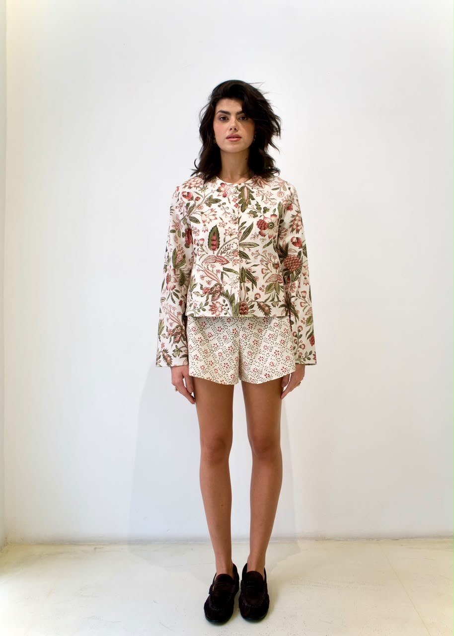Full-length front styling view of the Geometric green floral mini shorts, paired with the Fall Leaves Green OG Jacket