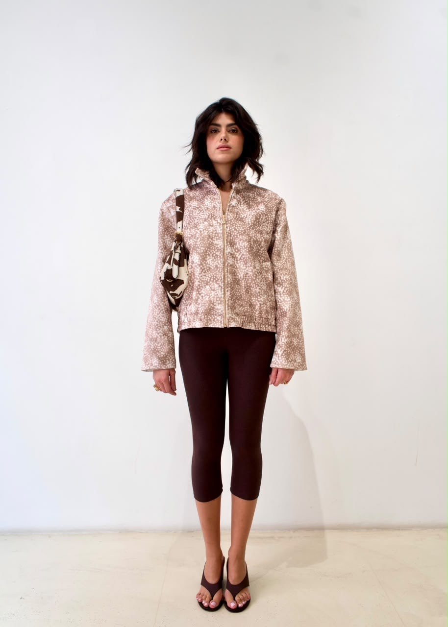 Front styling view of the taupe-and-white spotted Bambi White Boy Jacket with zip fastening and raised collar