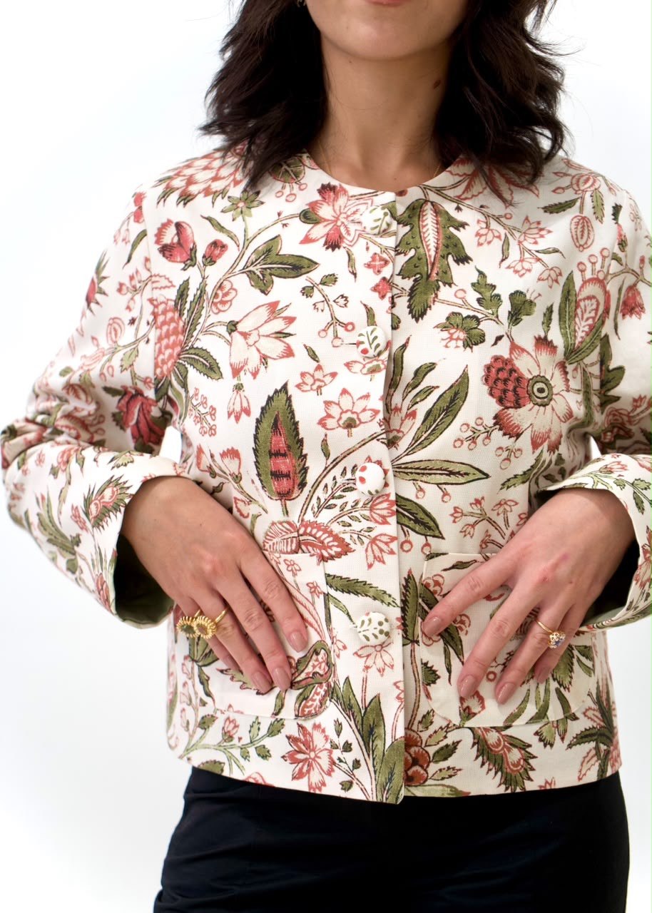 Close-up of the Fall Leaves Green OG Jacket with red-and-green botanical print, covered buttons and front patch pockets