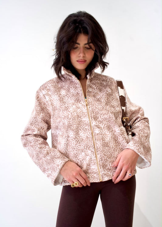 Front detail of the taupe-and-white spotted Bambi White Boy Jacket, showing the gold-tone zip and raised collar