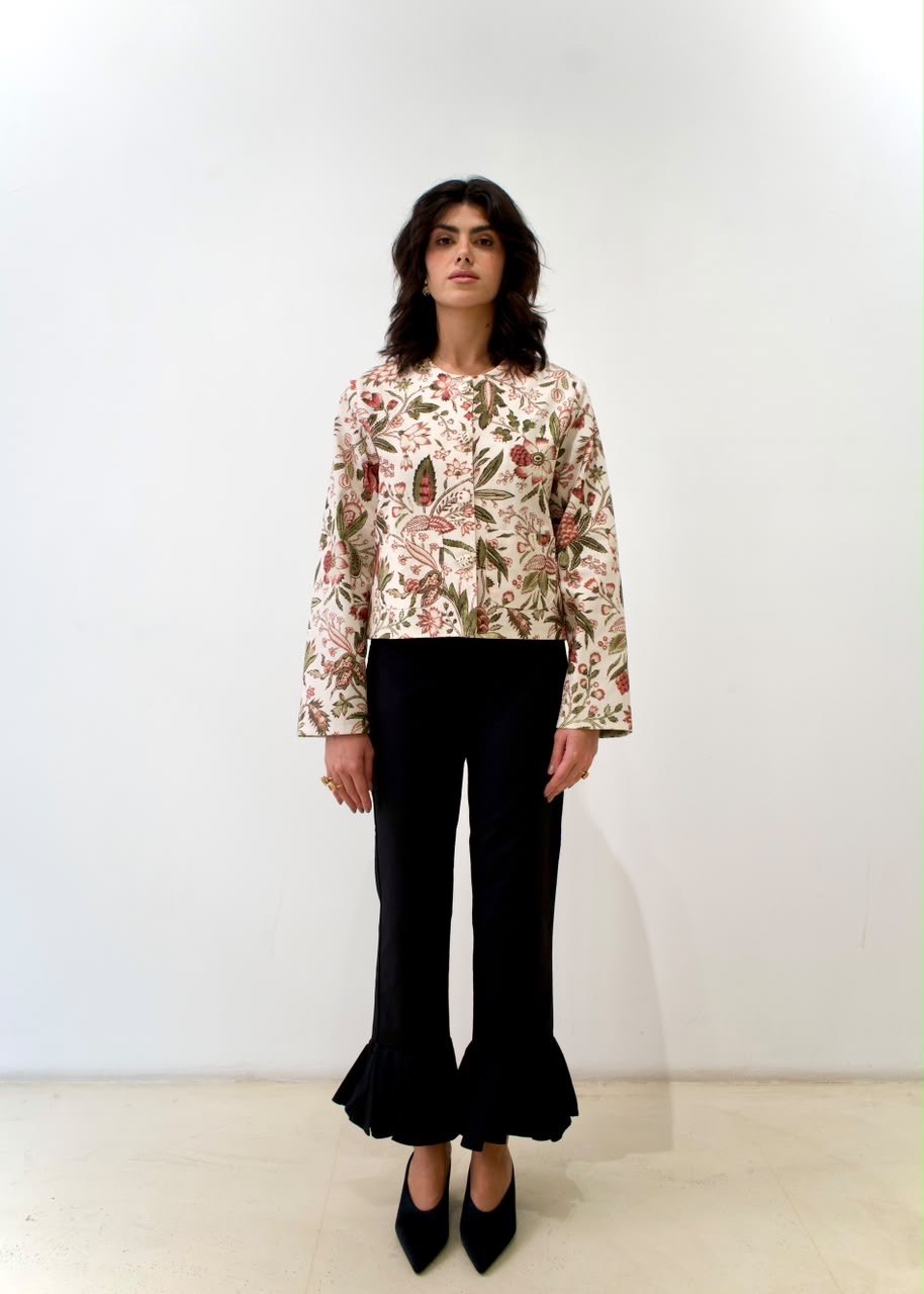 Full-length front styling view of the Fall Leaves Green OG Jacket with red-and-green botanical print, worn with black trousers