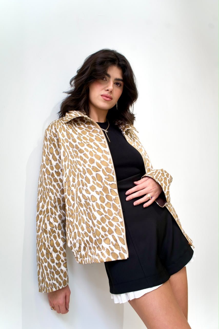 Angled front detail of the Golden Cheetah Boy Jacket, showing the point collar and zip fastening, worn open over a black outfit