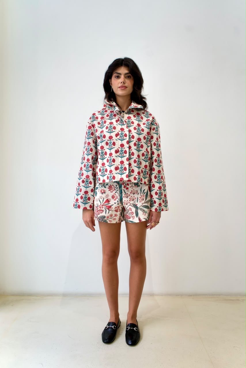 Full-length front view of the Indian Flower bomber jacket with raised collar and contrasting floral mini shorts