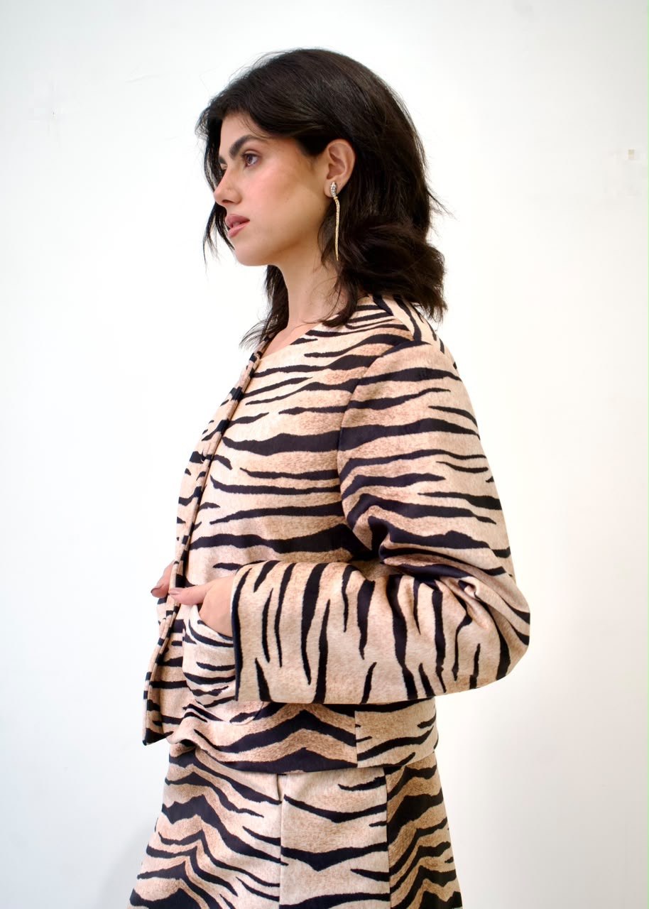 Side detail of the Tiger Black OG Jacket, showing the collarless neckline, tan-and-black tiger print and front patch pocket